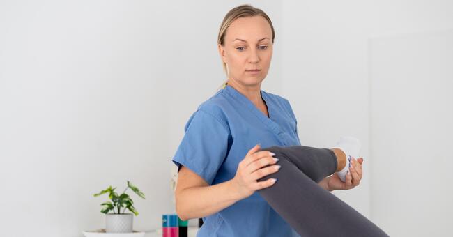 physiotherapist-helping-young-female-patient-her-c