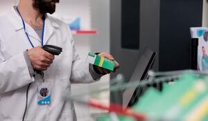 man-pharmacist-holding-store-scanner-that-reads-ba