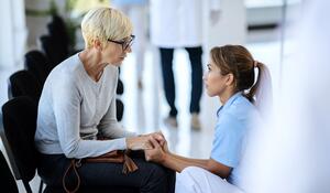 caring-nurse-consoling-mature-woman-waiting-room-m